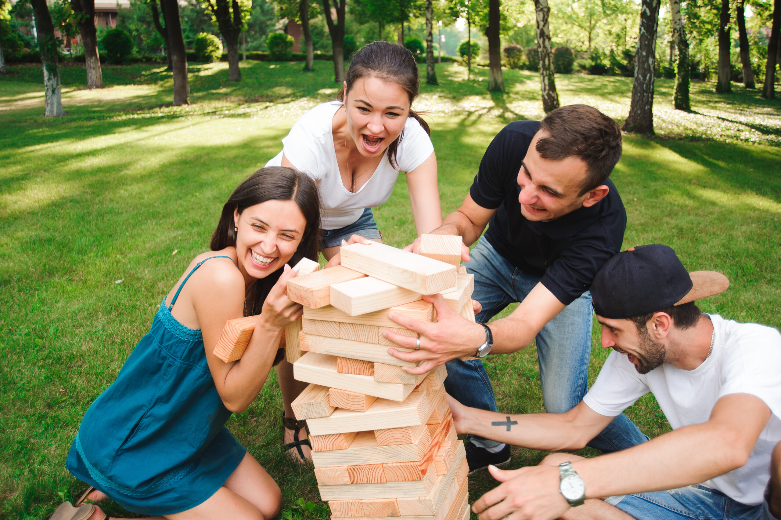 Friends playing board game outdoors.